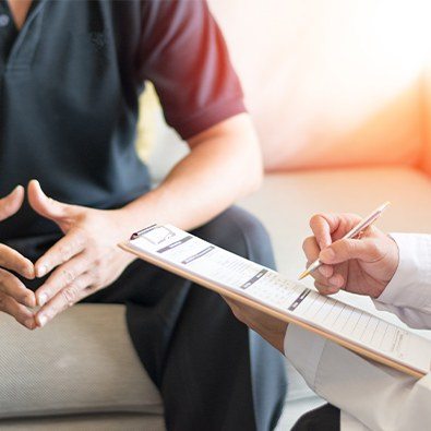 Doctor reviewing chronic pain treatment with patient