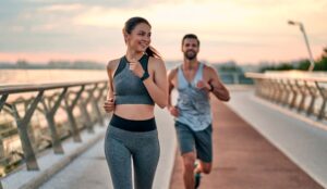 Happy couple jogging outdoors together